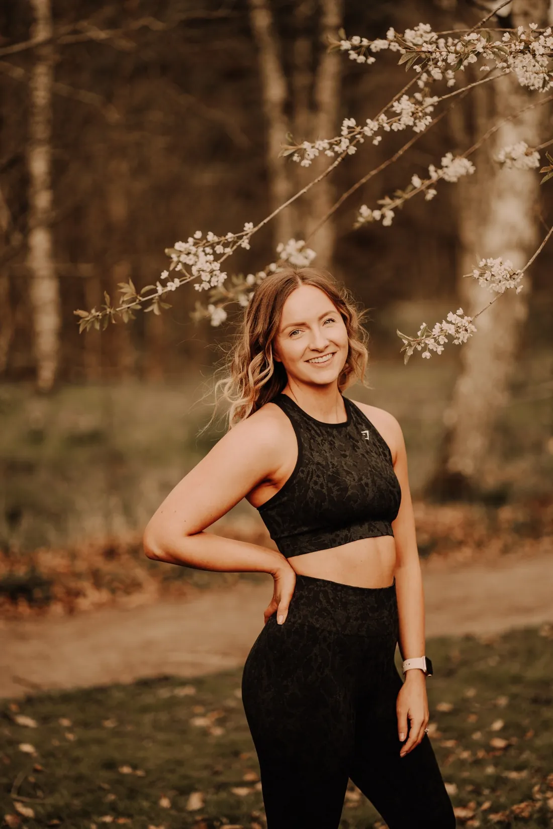 Claire smiling under cherry blossom